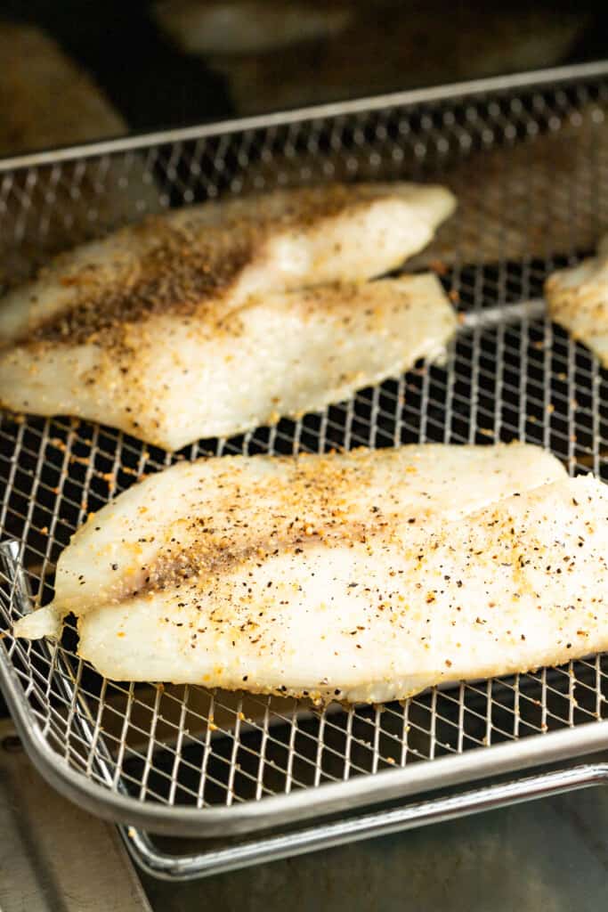 Taking tilapia out of the air fryer.