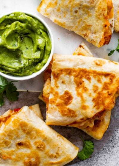 breakfast quesadillas with red pepper and cilantro served with guacamole