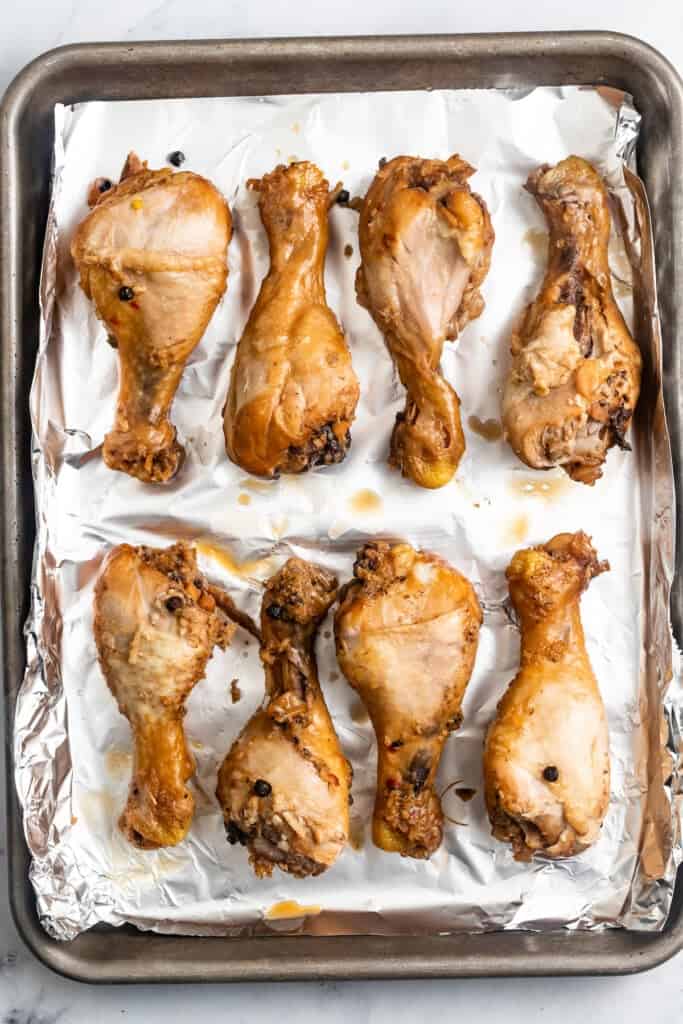 Chicken adobo on a sheet pan ready to be broiled.
