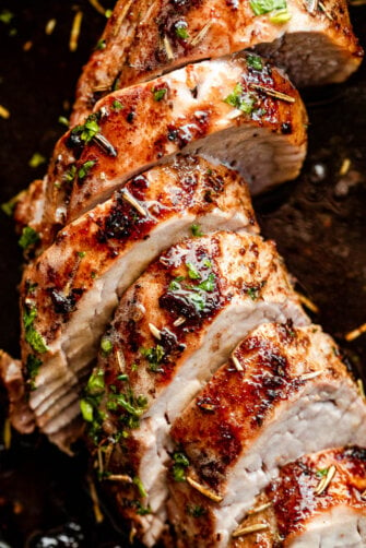 close up shot of slices of pork tenderloin on a dark background