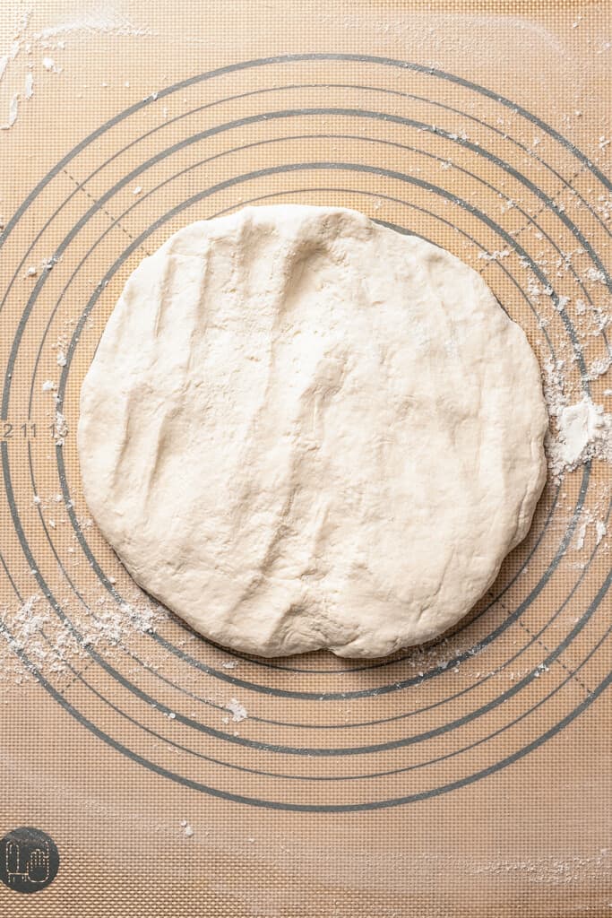 Rolling out dough on a baking mat.