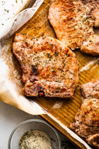 cooked ranch pork chops on a baking sheet
