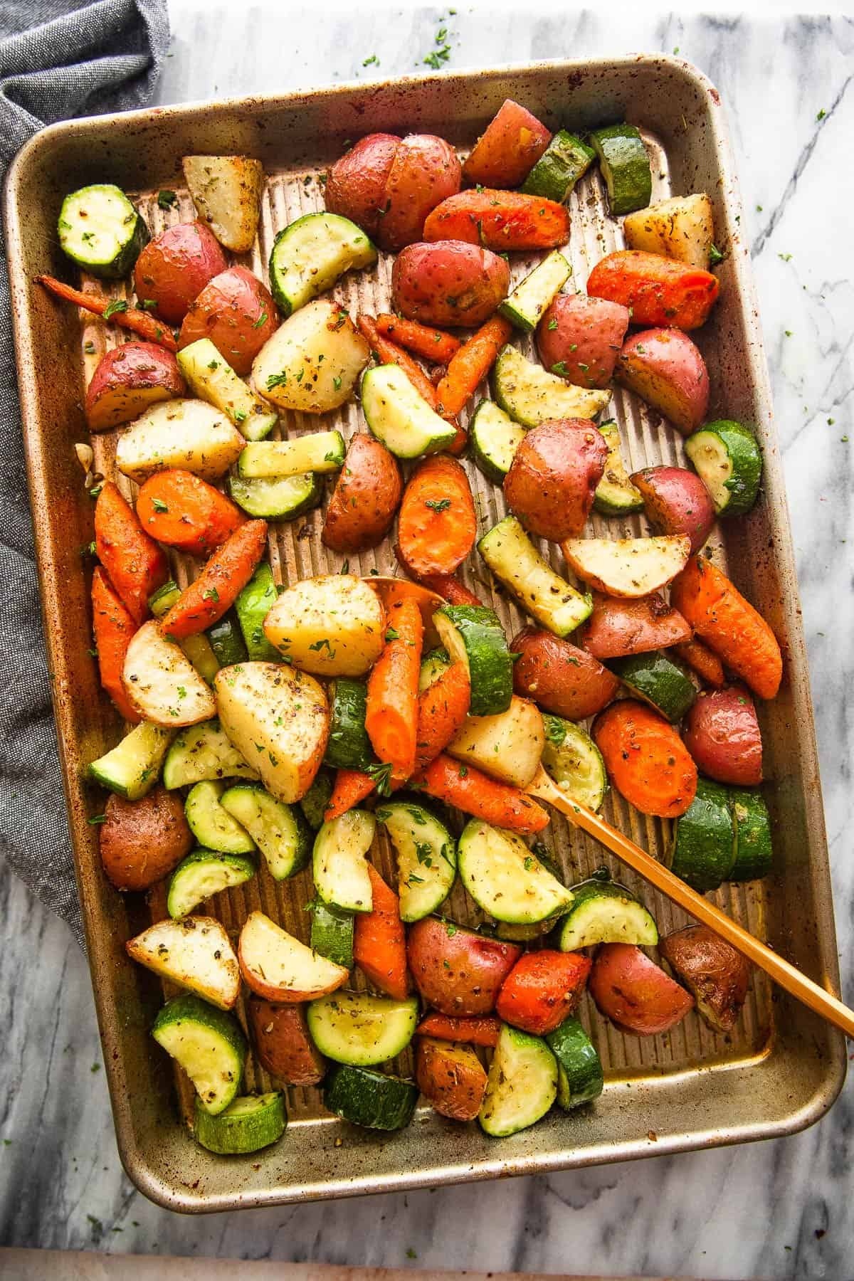 baking pan with roasted potatoes, carrots, and zucchini