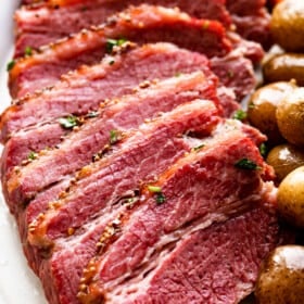 slow cooked corned beef sliced and served with potatoes and carrots