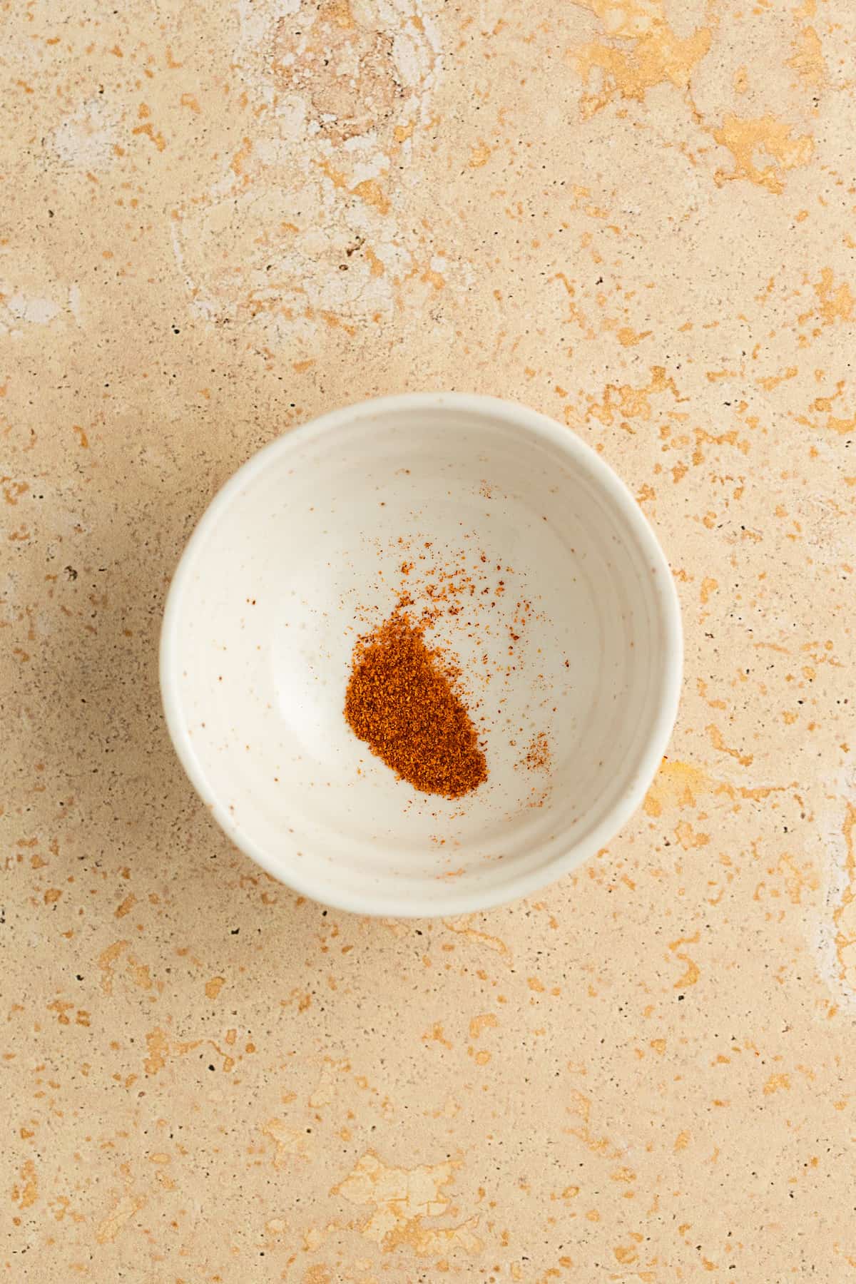 Placing the saffron threads in a small container.